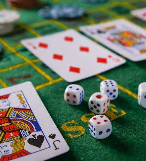 Gambling board game.Cards, chips, roulette.Gaming flat lay. Close-up of a card for playing poker on a gaming table in a casino against a background of chips. Background for the gaming business.